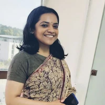 Radhika Jagtap, photographed in a kalamkari sari against soft window light.
